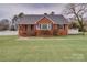 Charming brick home featuring a well-manicured lawn and classic architectural details, creating an inviting curb appeal at 204 Julia Ave, Belmont, NC 28012