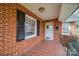 A brick home featuring a red brick front porch and white trimmed windows at 204 Julia Ave, Belmont, NC 28012