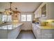 Bright white kitchen featuring stone countertops, pendant lighting, and stainless appliances at 204 Julia Ave, Belmont, NC 28012
