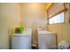 Functional laundry room with side-by-side washer and dryer and window at 204 Julia Ave, Belmont, NC 28012