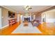 Inviting living room with hardwood floors, fireplace, ceiling fan and neutral colors at 204 Julia Ave, Belmont, NC 28012