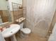 Cozy bathroom features a pedestal sink, toilet, and shower with neutral finishes at 2046 Cartier Way, Charlotte, NC 28208