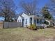 Blue brick home with white trim and a quaint covered front porch at 2046 Cartier Way, Charlotte, NC 28208