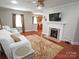 Cozy living room with fireplace, large windows, and hardwood flooring at 2046 Cartier Way, Charlotte, NC 28208