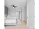 Bright bedroom features twin beds, neutral decor and a ceiling fan, complemented by light wood floors at 206 Freeland Ln, Charlotte, NC 28217