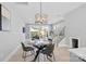 Open-concept dining area with glass-top table, stylish chairs, and seamless transition to the backyard and living room at 206 Freeland Ln, Charlotte, NC 28217