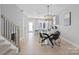 Inviting dining space with stylish light fixture and a view of the modern kitchen and staircase at 206 Freeland Ln, Charlotte, NC 28217
