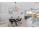 Cozy dining area with modern light fixture, table setting and adjacent living space at 206 Freeland Ln, Charlotte, NC 28217