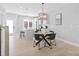 Modern dining area with stylish lighting, sleek table setting, and open layout to kitchen area at 206 Freeland Ln, Charlotte, NC 28217