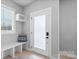 Bright entryway featuring a bench, decorative pillow, modern door, and natural light at 206 Freeland Ln, Charlotte, NC 28217