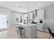 Contemporary kitchen features white cabinets, stainless steel appliances, and a functional island with bar seating at 206 Freeland Ln, Charlotte, NC 28217