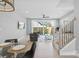 Comfortable living room with access to backyard patio, modern decor, and staircase at 206 Freeland Ln, Charlotte, NC 28217
