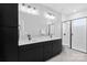 Modern bathroom featuring double sinks, a sleek vanity, and a glass-enclosed shower for a spa-like experience at 210 Freeland Ln, Charlotte, NC 28217