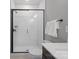 Modern bathroom showcasing a tiled shower with glass door, toilet, and vanity at 210 Freeland Ln, Charlotte, NC 28217
