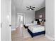 Neutral bedroom featuring two beds, ceiling fan, and light hardwood flooring throughout at 210 Freeland Ln, Charlotte, NC 28217