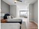 Neutral bedroom featuring two beds, ceiling fan, and light hardwood flooring throughout at 210 Freeland Ln, Charlotte, NC 28217