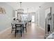 Bright dining area featuring a modern chandelier, kitchen view, and sleek flooring for contemporary living at 210 Freeland Ln, Charlotte, NC 28217