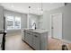 Contemporary kitchen island featuring sleek cabinetry, modern pendant lighting, and an efficient stainless-steel dishwasher at 210 Freeland Ln, Charlotte, NC 28217