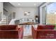 Comfortable living room featuring modern decor, a sliding door to the backyard, and hardwood floors at 210 Freeland Ln, Charlotte, NC 28217