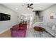 Open-concept living room with hardwood floors, modern furniture, and a view of the staircase and kitchen at 210 Freeland Ln, Charlotte, NC 28217