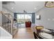 Bright living room with a sliding glass door to the backyard, showcasing modern decor and an open staircase at 210 Freeland Ln, Charlotte, NC 28217