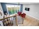 Stylish loft area with cozy seating, a view of the fenced backyard, and an open floor plan at 210 Freeland Ln, Charlotte, NC 28217