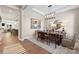 Elegant dining room with modern chandelier, set table, neutral walls, and stylish decor for gatherings at 2227 Indigo Branch Rd, Indian Land, SC 29707