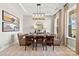 Well decorated dining room with modern chandelier, set table, neutral walls, and stylish decor at 2227 Indigo Branch Rd, Indian Land, SC 29707