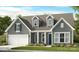 Charming single-Gathering home featuring a gabled roof, attached garage, well-maintained lawn, and inviting curb appeal at 2227 Indigo Branch Rd, Indian Land, SC 29707