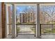 View from private balcony, with wrought iron railings, overlooking trees and building at 2251 Selwyn Ave # 201, Charlotte, NC 28207