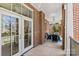 Inviting porch with brick columns, ceiling fans, and comfortable seating arrangement at 2251 Selwyn Ave # 201, Charlotte, NC 28207