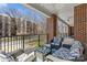 Cozy porch with brick columns, ceiling fan, and comfortable outdoor seating with a view at 2251 Selwyn Ave # 201, Charlotte, NC 28207