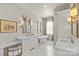 A luxurious bathroom with a marble floor, soaking tub, double vanity, and elegant fixtures at 2251 Selwyn Ave # 201, Charlotte, NC 28207
