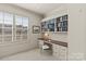 Comfortable room featuring a built-in desk with shelving and a bright window at 2251 Selwyn Ave # 201, Charlotte, NC 28207