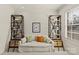 Inviting bedroom space with a comfortable couch and custom built-in shelving with ladders at 2251 Selwyn Ave # 201, Charlotte, NC 28207