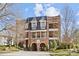 Elegant brick building with arched entryway and balconies, set against a bright sky at 2251 Selwyn Ave # 201, Charlotte, NC 28207
