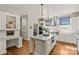 Well-lit kitchen boasts granite island, stainless appliances, and white cabinetry at 2251 Selwyn Ave # 201, Charlotte, NC 28207
