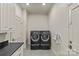 This laundry room features a sleek black washer and dryer set and ample cabinet space at 2251 Selwyn Ave # 201, Charlotte, NC 28207