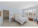 Light filled bedroom featuring a cozy sitting area, soft carpet, and bright window at 2251 Selwyn Ave # 201, Charlotte, NC 28207