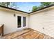 Wooden deck with white brick and siding and glass panel doors at 228 Tot Dellinger Rd, Cherryville, NC 28021
