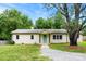 Charming single-story brick home with a well-maintained front yard, gravel driveway, and a lovely, light green front door at 228 Tot Dellinger Rd, Cherryville, NC 28021