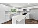 Elegant kitchen with white cabinets, an island, stainless steel appliances and hardwood floors, flooded with natural light at 228 Tot Dellinger Rd, Cherryville, NC 28021