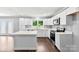 Modern kitchen featuring white cabinets, stainless steel appliances, and a center island with counter seating and hardwood floors at 228 Tot Dellinger Rd, Cherryville, NC 28021