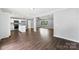 Open-concept living room featuring hardwood floors and a modern kitchen with a center island at 228 Tot Dellinger Rd, Cherryville, NC 28021