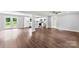 Bright, open-concept living room with hardwood floors, a ceiling fan, and French doors leading to the outdoors at 228 Tot Dellinger Rd, Cherryville, NC 28021