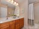 Bathroom with a double vanity, framed mirrors and bathtub with shower at 244 Hurston Cir, Charlotte, NC 28208
