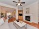 Open living room showcases hardwood floors, fireplace, and seamless transition to dining area at 244 Hurston Cir, Charlotte, NC 28208