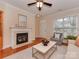 Inviting living room featuring a fireplace, hardwood floors, and an abundance of natural light at 244 Hurston Cir, Charlotte, NC 28208