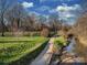 Scenic walking path beside a creek, perfect for a relaxing stroll in the neighborhood at 244 Hurston Cir, Charlotte, NC 28208