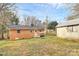 Brick home with a modest backyard and a detached outbuilding or shed at 2548 Milton Ave, Gastonia, NC 28052